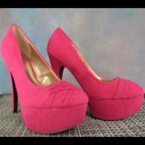 Pink suede closed toe platform slip-on heel.